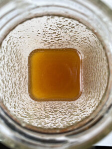 The inside of a jar of runny honey